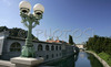 Lamp on Dragon bridge with Central market on nice late summer day. Open-air central market was designed and built by Slovene architect Joze Plecnik between 1940 and 1944. In late summer when temperatures are still around 25 degres Celsius, Slovene capital city Ljubljana is still crammed with tourists from all over the world, who are discovering city secrets by foot.
