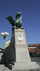 Statues of dragon guards Dragon bridge on nice late summer day. In late summer when temperatures are still around 25 degres Celsius, Slovene capital city Ljubljana is still crammed with tourists from all over the world, who are discovering city secrets by foot.
