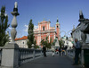 Tromostovje (the Triple Bridge) with The Franciscan monastery and the Church of the Annunciation and the Presernov trg Square on background on nice late summer day. In late summer when temperatures are still around 25 degres Celsius, Slovene capital city Ljubljana is still crammed with tourists from all over the world, who are discovering city secrets by foot.
