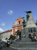 Tromostovje (the Triple Bridge) with The Franciscan monastery and the Church of the Annunciation and the Presernov trg Square on background on nice late summer day. In late summer when temperatures are still around 25 degres Celsius, Slovene capital city Ljubljana is still crammed with tourists from all over the world, who are discovering city secrets by foot.

