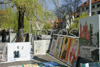 Artists are displaying their art work on river banks of Ljubljanica river in Ljubljana, Slovenia, on warm and sunny spring day.
