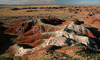 Painted desert bandlands are located on North part of Petrified forest National Park. Petrified Forest National park preserves the largest concentration of petrified wood in North America, perhaps in the World. What sets it apart from other petrified wood sites is its scenic surroundings of badlands, which provide an otherworldly feeling to the experience. Petrified Forest National park is situated approximately 20 miles east of Holbrook, AZ, USA 
