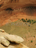 Ruins of House under the Rock below in Canyon de Chelly. Canyon de Chelly National Monument is located near Chinle, AZ, USA and is hiding numerous house ruins of Navajo Indians, which were settled in Canyon de Chelly. Labyrinth called Canyon de Chelly is really several canyons, which include Canyon de Chelly and Canyon del Muerto. At the mouth of the canyon the rock walls are only 30 feet high. Deeper into the canyons, to the east, the walls rise dramatically until they reach more than 1000 feet above the floor. The cliffs rise straight up, overshadowing the streams, cottonwoods, and small farms below. It has taken about two million years and volumes of water to etch these stone paths through the layers of sandstone and igneous rock as the Defiance Plateau pushed its way upward. Today the canyon still beckons us with its towering stone monoliths and ledges bearing the open windows of ancient people.
