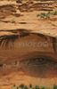 Ruins of House under the Rock below in Canyon de Chelly. Canyon de Chelly National Monument is located near Chinle, AZ, USA and is hiding numerous house ruins of Navajo Indians, which were settled in Canyon de Chelly. Labyrinth called Canyon de Chelly is really several canyons, which include Canyon de Chelly and Canyon del Muerto. At the mouth of the canyon the rock walls are only 30 feet high. Deeper into the canyons, to the east, the walls rise dramatically until they reach more than 1000 feet above the floor. The cliffs rise straight up, overshadowing the streams, cottonwoods, and small farms below. It has taken about two million years and volumes of water to etch these stone paths through the layers of sandstone and igneous rock as the Defiance Plateau pushed its way upward. Today the canyon still beckons us with its towering stone monoliths and ledges bearing the open windows of ancient people.
