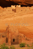 White house ruin below in Canyon de Chelly. White house was built  by ancient Puebloan people and occupied around 1000 years ago.  It is named for the long wall in the upper dwelling that is covered with white plaster. Canyon de Chelly National Monument is located near Chinle, AZ, USA and is hiding numerous house ruins of Navajo Indians, which were settled in Canyon de Chelly. Labyrinth called Canyon de Chelly is really several canyons, which include Canyon de Chelly and Canyon del Muerto. At the mouth of the canyon the rock walls are only 30 feet high. Deeper into the canyons, to the east, the walls rise dramatically until they reach more than 1000 feet above the floor. The cliffs rise straight up, overshadowing the streams, cottonwoods, and small farms below. It has taken about two million years and volumes of water to etch these stone paths through the layers of sandstone and igneous rock as the Defiance Plateau pushed its way upward. Today the canyon still beckons us with its towering stone monoliths and ledges bearing the open windows of ancient people.
