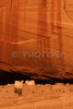 White house ruin below in Canyon de Chelly. White house was built  by ancient Puebloan people and occupied around 1000 years ago.  It is named for the long wall in the upper dwelling that is covered with white plaster. Canyon de Chelly National Monument is located near Chinle, AZ, USA and is hiding numerous house ruins of Navajo Indians, which were settled in Canyon de Chelly. Labyrinth called Canyon de Chelly is really several canyons, which include Canyon de Chelly and Canyon del Muerto. At the mouth of the canyon the rock walls are only 30 feet high. Deeper into the canyons, to the east, the walls rise dramatically until they reach more than 1000 feet above the floor. The cliffs rise straight up, overshadowing the streams, cottonwoods, and small farms below. It has taken about two million years and volumes of water to etch these stone paths through the layers of sandstone and igneous rock as the Defiance Plateau pushed its way upward. Today the canyon still beckons us with its towering stone monoliths and ledges bearing the open windows of ancient people.
