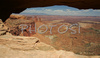 Mesa Arch in Canyonlands National Park. Canyonlands preserves a wilderness of rock at the heart of the Colorado Plateau. Water and gravity have been the prime architects of this land, cutting flat layers of sedimentary rock into hundreds of canyons, mesas, buttes, fins, arches, and spires. At center stage are two canyons carved by the Green and Colorado rivers. Surrounding the rivers are vast and very different regions, Island in the Sky on north, the Maze at west and the Needles at east. Canyonlands national park is located near Moab, Utah, USA.
