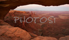 Mesa Arch in Canyonlands National Park. Canyonlands preserves a wilderness of rock at the heart of the Colorado Plateau. Water and gravity have been the prime architects of this land, cutting flat layers of sedimentary rock into hundreds of canyons, mesas, buttes, fins, arches, and spires. At center stage are two canyons carved by the Green and Colorado rivers. Surrounding the rivers are vast and very different regions, Island in the Sky on north, the Maze at west and the Needles at east. Canyonlands national park is located near Moab, Utah, USA.
