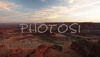 Sunset over Canyonlands, Utah, USA, from Dead Horse Point in Dead Horse Point State park, Utah, USA. Canyonlands preserves a wilderness of rock at the heart of the Colorado Plateau. Water and gravity have been the prime architects of this land, cutting flat layers of sedimentary rock into hundreds of canyons, mesas, buttes, fins, arches, and spires. At center stage are two canyons carved by the Green and Colorado rivers. Surrounding the rivers are vast and very different regions, Island in the Sky on north, the Maze at west and the Needles at east. Canyonlands national park is located near Moab, Utah, USA.
