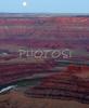 Sunset over Canyonlands, Utah, USA, from Dead Horse Point in Dead Horse Point State park, Utah, USA. Canyonlands preserves a wilderness of rock at the heart of the Colorado Plateau. Water and gravity have been the prime architects of this land, cutting flat layers of sedimentary rock into hundreds of canyons, mesas, buttes, fins, arches, and spires. At center stage are two canyons carved by the Green and Colorado rivers. Surrounding the rivers are vast and very different regions, Island in the Sky on north, the Maze at west and the Needles at east. Canyonlands national park is located near Moab, Utah, USA.
