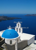 Traditional Greek houses in Firostefani are scattered on caldera on Santorini island. White houses with bright blue elements like roofs, windows, doors or fences on dark, almost black rocks of vulcano island Santorini, are trademark of Santorini, knows worldwide.
