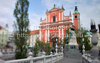 Tromostovje (the Triple Bridge) with The Franciscan monastery and the Church of the Annunciation and the Presernov trg Square on background in center of Ljubljana, Slovenia. Tromostovje is one of bridges crossing Ljubljanica river in old part of Ljubljana city. During spring months middle of city is still deserted on weekend, but as soon as temperatures rise, numerous cafes on side of Ljubljanica river open, and city is blooming just as trees in city parks are.
