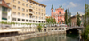 Tromostovje (the Triple Bridge) with The Franciscan monastery and the Church of the Annunciation and the Presernov trg Square on background in center of Ljubljana, Slovenia. Tromostovje is one of bridges crossing Ljubljanica river in old part of Ljubljana city. During spring months middle of city is still deserted on weekend, but as soon as temperatures rise, numerous cafes on side of Ljubljanica river open, and city is blooming just as trees in city parks are.

