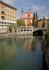 Tromostovje (the Triple Bridge) with The Franciscan monastery and the Church of the Annunciation and the Presernov trg Square on background in center of Ljubljana, Slovenia. Tromostovje is one of bridges crossing Ljubljanica river in old part of Ljubljana city. During spring months middle of city is still deserted on weekend, but as soon as temperatures rise, numerous cafes on side of Ljubljanica river open, and city is blooming just as trees in city parks are.
