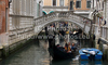 People are enjoying moments on canals of Venice, Italy, traveling around with gondolas. The gondola is a traditional, flat-bottomed Venetian rowing boat, well suited to the conditions of the Venetian lagoon. For centuries gondolas were the chief means of transportation and most common watercraft within Venice. In modern times the iconic boats still have a role in public transport in the city, serving as traghetti (ferries) over the Grand Canal.
