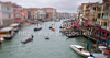 View to busy Grand Canal (Canal Grande) from the Rialto Bridge in Venice, Italy. The Rialto Bridge (Ponte di Rialto) is one of the four bridges spanning the Grand Canal in Venice, Italy. It is the oldest bridge across the canal, and was the dividing line for the districts of San Marco and San Polo. 
