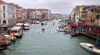 View to busy Grand Canal (Canal Grande) from the Rialto Bridge in Venice, Italy. The Rialto Bridge (Ponte di Rialto) is one of the four bridges spanning the Grand Canal in Venice, Italy. It is the oldest bridge across the canal, and was the dividing line for the districts of San Marco and San Polo. 
