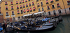 People are enjoying moments on canals of Venice, Italy, traveling around with gondolas. The gondola is a traditional, flat-bottomed Venetian rowing boat, well suited to the conditions of the Venetian lagoon. For centuries gondolas were the chief means of transportation and most common watercraft within Venice. In modern times the iconic boats still have a role in public transport in the city, serving as traghetti (ferries) over the Grand Canal.
