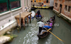 People are enjoying moments on canals of Venice, Italy, traveling around with gondolas. The gondola is a traditional, flat-bottomed Venetian rowing boat, well suited to the conditions of the Venetian lagoon. For centuries gondolas were the chief means of transportation and most common watercraft within Venice. In modern times the iconic boats still have a role in public transport in the city, serving as traghetti (ferries) over the Grand Canal.
