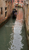 People are enjoying moments on canals of Venice, Italy, traveling around with gondolas. The gondola is a traditional, flat-bottomed Venetian rowing boat, well suited to the conditions of the Venetian lagoon. For centuries gondolas were the chief means of transportation and most common watercraft within Venice. In modern times the iconic boats still have a role in public transport in the city, serving as traghetti (ferries) over the Grand Canal.
