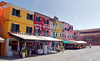 Burano is an island in the Venetian Lagoon, Italy. Like Venice itself, it could more correctly be called an archipelago of four islands linked by bridges. It is situated near Torcello at the northern end of the Lagoon, and is known for its lacework and brightly colored homes. <br> Small, brightly-painted houses on Burano follow a specific system originating from the golden age of its development. If someone wishes to paint their home, one must send a request to the government, who will respond by making notice of the certain colors permitted for that lot.
