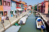 Burano is an island in the Venetian Lagoon, Italy. Like Venice itself, it could more correctly be called an archipelago of four islands linked by bridges. It is situated near Torcello at the northern end of the Lagoon, and is known for its lacework and brightly colored homes. <br> Small, brightly-painted houses on Burano follow a specific system originating from the golden age of its development. If someone wishes to paint their home, one must send a request to the government, who will respond by making notice of the certain colors permitted for that lot.
