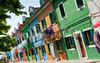 Burano is an island in the Venetian Lagoon, Italy. Like Venice itself, it could more correctly be called an archipelago of four islands linked by bridges. It is situated near Torcello at the northern end of the Lagoon, and is known for its lacework and brightly colored homes. <br> Small, brightly-painted houses on Burano follow a specific system originating from the golden age of its development. If someone wishes to paint their home, one must send a request to the government, who will respond by making notice of the certain colors permitted for that lot.
