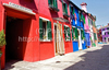 Burano is an island in the Venetian Lagoon, Italy. Like Venice itself, it could more correctly be called an archipelago of four islands linked by bridges. It is situated near Torcello at the northern end of the Lagoon, and is known for its lacework and brightly colored homes. <br> Small, brightly-painted houses on Burano follow a specific system originating from the golden age of its development. If someone wishes to paint their home, one must send a request to the government, who will respond by making notice of the certain colors permitted for that lot.

