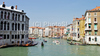 View to busy Grand Canal (Canal Grande) from the Rialto Bridge in Venice, Italy. The Rialto Bridge (Ponte di Rialto) is one of the four bridges spanning the Grand Canal in Venice, Italy. It is the oldest bridge across the canal, and was the dividing line for the districts of San Marco and San Polo. 
