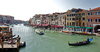 View to busy Grand Canal (Canal Grande) from the Rialto Bridge in Venice, Italy. The Rialto Bridge (Ponte di Rialto) is one of the four bridges spanning the Grand Canal in Venice, Italy. It is the oldest bridge across the canal, and was the dividing line for the districts of San Marco and San Polo. 
