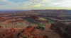 Sunset over Canyonlands, Utah, USA, from Dead Horse Point in Dead Horse Point State park, Utah, USA. Canyonlands preserves a wilderness of rock at the heart of the Colorado Plateau. Water and gravity have been the prime architects of this land, cutting flat layers of sedimentary rock into hundreds of canyons, mesas, buttes, fins, arches, and spires. At center stage are two canyons carved by the Green and Colorado rivers. Surrounding the rivers are vast and very different regions, Island in the Sky on north, the Maze at west and the Needles at east. Canyonlands national park is located near Moab, Utah, USA.
