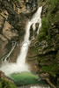 The Savica runs over 38 m long level and falls almost 51 m deep. Total difference in height is 78 m. Another smaller waterfall also falls 25 m deep. Both waterfalls together form the two-part waterfall in the shape of the letter A. Right after the pool, which is artificially supported, is a small dam. <br> Bohinj Lake has numerous inflows, the most important one is the Savica. Its water bursts from the underground of the Dolina sedmerih jezer (The Seven Triglav Lakes Valley) in the walls of Komarca as Savica Waterfall, which is the most famous Slovenian waterfall.  <br> Lake Bohinj lies between Bohinjs mountains, which rise from 1600 to 2000 meters, and is Slovenias largest glacial lake. It is 4.2 kilometers long, one kilometer wide, and forty-five meters deep. <br> Bohinj is a valley that stretches from Soteska to Ukanc. On the south side, it is enclosed by the Lower Bohinj Mountains, which rise to 2.000 meters, and on the north by the Triglav mountain range with 2864m high Mount Triglav, Slovenias highest mountain.

