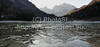 Half frozen lake Jasna near Kranjska Gora, Slovenia on early autumn morning. First snow has covered top of higher mountains, while valleys are still in late autumn with fog and no snow.
