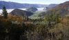 Forest in autumn colors is rising above valley of Bohinj, Slovenia, which is still covered with thick morning fog. View over the valley from Vodnikov razglednik near village Koprivnik, Slovenia, is outstanding and it takes breath away on such sunny morning.
