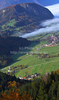 Forest in autumn colors is rising above valley of Bohinj, Slovenia, which is still covered with thick morning fog. View over the valley from Vodnikov razglednik near village Koprivnik, Slovenia, is outstanding and it takes breath away on such sunny morning.
