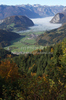 Forest in autumn colors is rising above valley of Bohinj, Slovenia, which is still covered with thick morning fog. View over the valley from Vodnikov razglednik near village Koprivnik, Slovenia, is outstanding and it takes breath away on such sunny morning.
