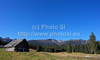 Old shepherds houses on Javorniska Planina in Pokljuka are waiting for snow to come, while mountain of Triglav in background is already covered with snow. Winter and cold is slowly coming to meadows of Javorniska Planina in Pokljuka, Slovenia, on sunny and cold morning of Saturday, 17th of November 2012.
