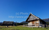 Old shepherds houses on Javorniska Planina in Pokljuka are waiting for snow to come, while mountain of Triglav in background is already covered with snow. Winter and cold is slowly coming to meadows of Javorniska Planina in Pokljuka, Slovenia, on sunny and cold morning of Saturday, 17th of November 2012.
