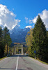 Bridge leading over Sava river near village of Martuljek, Slovenia, on sunny autumn day. In background is north wall of Spik mountain covered with early snow.
