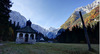 Mary Help chapel in Tamar is in shadow thrown by nearby mountains on early autumn morning, when temperatures fall under freezing level. mountaineering
