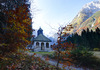Mary Help chapel in Tamar is in shadow thrown by nearby mountains on early autumn morning, when temperatures fall under freezing level. mountaineering
