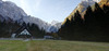 Mountaineering hut on the end of Tamar valley is in shadow thrown by nearby mountains on early autumn morning, when temperatures fall under freezing level. mountaineering
