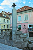 Plecnik Fountain  <br>  <br> The architect Joze Plecnik had planned to make a monumental entrance into the town. He transformed the steep slope into a staircase and replaced the former well (called sterna) with an obelisk topped by a bronze rooster from which the water runs into stone, terraced vessels. The fountain is an interpretation of the Garden of Eden at Hradcany, Prague. <br> 
