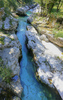 Emerald green Soca river is flowing through deep and narrow gorge near vas Soca, Slovenia.
