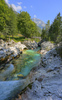 Emerald green Soca river is flowing through deep and narrow gorge near vas Soca, Slovenia.
