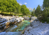 Emerald green Soca river is flowing through deep and narrow gorge near vas Soca, Slovenia.
