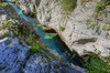 Emerald green Soca river is flowing through deep and narrow gorge near vas Soca, Slovenia.
