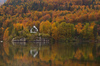 View to Bohinj lake in Bohinj, Slovenia, surrounded by trees already painted in autumn colors on Saturday, 17th of October 2015.
