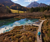 Nordic walking around Zelenci spring, near Kranjska Gora, Slovenia. Zelenci is a spring and nature reserve near village of Kranjska Gora, Slovenia. Zelenci spring is source of Sava river. At Zelenci, water from the underground stream Nadiza emerges through the porous lake bottom, whose waters are noted for their deep, brilliant green. The spring and its surrounding area are named after this color, as zelen meaning green in Slovene. 
