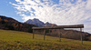 View to Ponca, mountain on Slovenia Italy border, from field near Kranjska Gora, Slovenia, with traditional hayrack in foreground.
